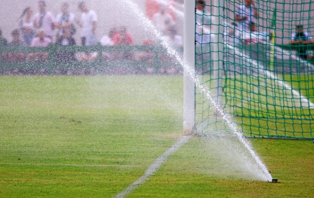 water sprinklers on football field showing water suppliers.