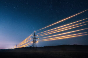 electricity towers with orange glowing wires representing market wide half hourly meter settlements